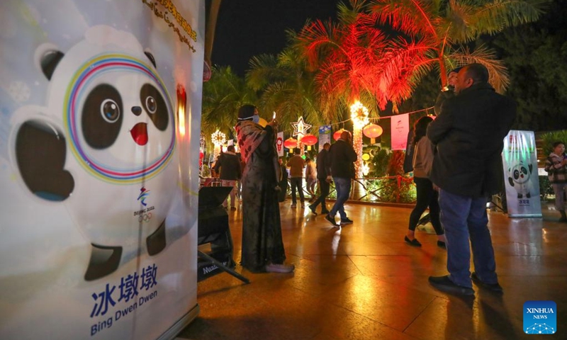 People take pictures during a light show for the Beijing Winter Olympics at the Cairo Tower in Cairo, Egypt, on Jan. 24, 2022. A light show was held at the Cairo Tower for the upcoming Beijing 2022 Winter Olympics.(Photo: Xinhua)