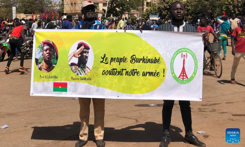 Photo taken on Jan. 25, 2022 with a cellphone shows demonstrators holding a placard at Place de la Nation in support of the army in Ouagadougou, Burkina Faso. Burkina Faso soldiers said Monday on national television that they had seized power and put an end to the functions of President Roch Kabore. The Patriotic Movement for Safeguard and Restoration (MPSR) took power, led by Lieutenant-Colonel Paul-Henri Sandaogo Damiba. (Photo by Jean-Paul Ouedraogo/Xinhua)