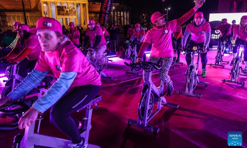 Participants ride spinning machines during a promotional event of Giro d'Italia 2022 bike race held on Heroes Square in Budapest, Hungary on Jan. 26, 2022. The race will start on May 6. (Photo by Csaba Domotor/Xinhua)