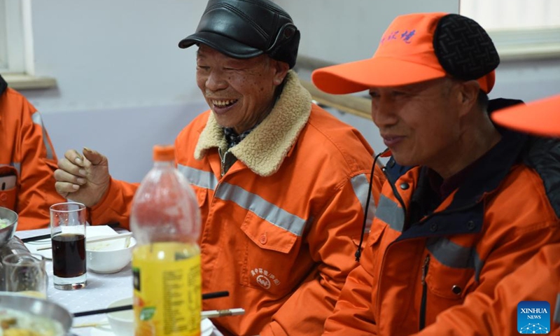 Sanitation workers have a reunion dinner at Gongwan Road sanitation station in Luyang District, Hefei, east China's Anhui Province, Jan. 24, 2022. Local urban management bureau on Monday offered a reunion dinner for more than 40 sanitation workers who choose to stay put at their positions during the upcoming Spring Festival.(Photo: Xinhua)