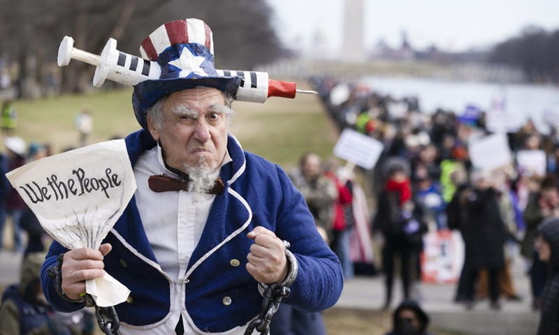 A man poses while attending an event protesting vaccine mandates and other pandemic restrictions in Washington, D.C., the United States, Jan. 23, 2022.(Photo: Xinhua)
