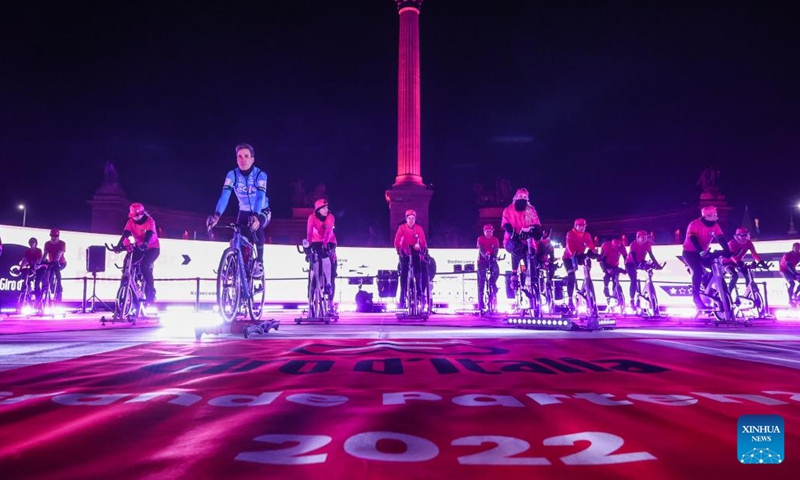 Participants ride spinning machines during a promotional event of Giro d'Italia 2022 bike race held on Heroes Square in Budapest, Hungary on Jan. 26, 2022. The race will start on May 6. (Photo by Csaba Domotor/Xinhua)