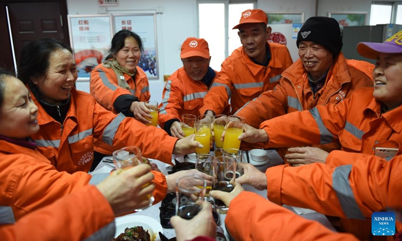 Sanitation workers have a reunion dinner at Gongwan Road sanitation station in Luyang District, Hefei, east China's Anhui Province, Jan. 24, 2022. Local urban management bureau on Monday offered a reunion dinner for more than 40 sanitation workers who choose to stay put at their positions during the upcoming Spring Festival.(Photo: Xinhua)