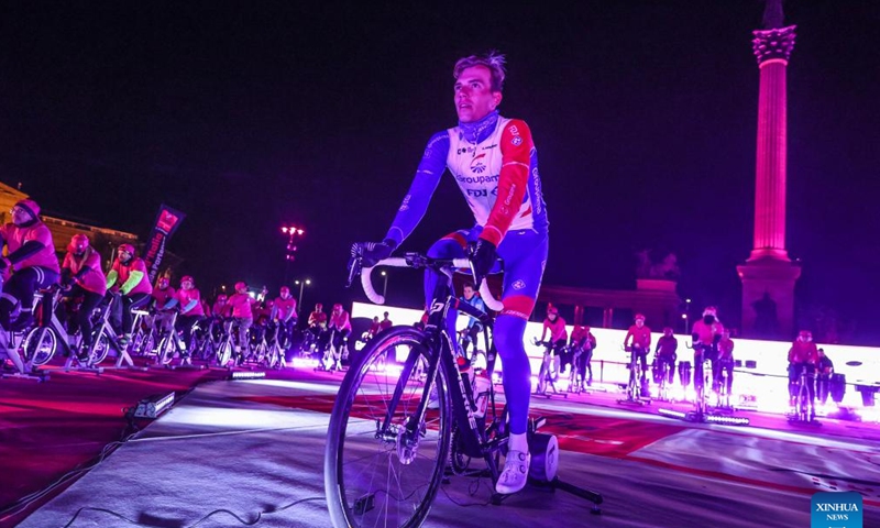 Participants ride spinning machines during a promotional event of Giro d'Italia 2022 bike race held on Heroes Square in Budapest, Hungary on Jan. 26, 2022. The race will start on May 6. (Photo by Csaba Domotor/Xinhua)
