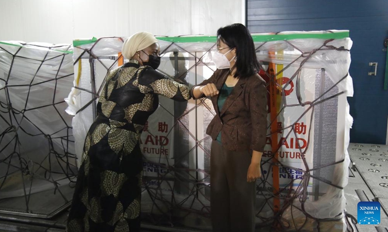 Chinese Ambassador to Tanzania Chen Mingjian (R) touches elbows with Tanzanian Minister of Health, Community Development, Gender, Elderly and Children Ummy Mwalimu during a handover ceremony of COVID-19 vaccines at the Julius Nyerere International Airport in Dar es Salaam, Tanzania, on Jan. 26, 2022.Photo:Xinhua