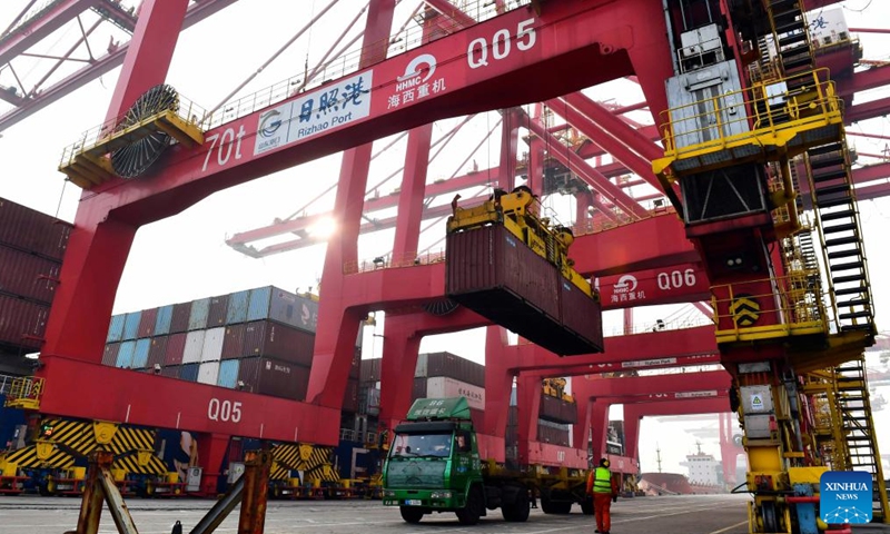A container is loaded onto a truck at the Rizhao Port in Rizhao, east China's Shandong Province, Jan. 26, 2022.Photo:Xinhua
