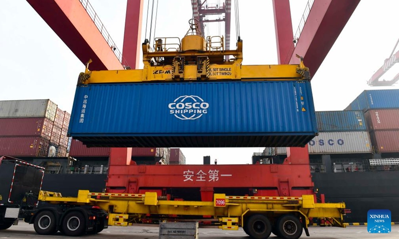 A container is loaded onto a truck at the Rizhao Port in Rizhao, east China's Shandong Province, Jan. 26, 2022.Photo:Xinhua