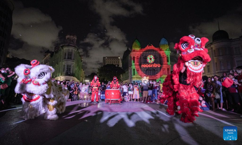 People perform a lion dance during a light show celebrating the upcoming Chinese Lunar New Year and Beijing 2022 Winter Olympics in Recife, Brazil, on Jan. 30, 2022. (Xinhua/Wang Tiancong)