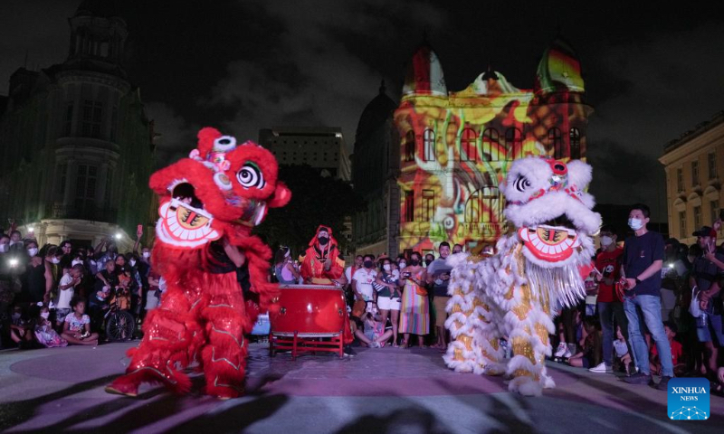 People perform a lion dance during a light show celebrating the upcoming Chinese Lunar New Year and Beijing 2022 Winter Olympics in Recife, Brazil, on Jan. 30, 2022. (Xinhua/Wang Tiancong)