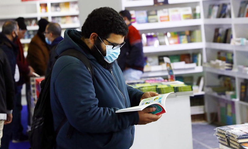 A man reads a book while visiting the Cairo International Book Fair in Cairo, Egypt, on Jan. 27, 2022.(Photo: Xinhua)