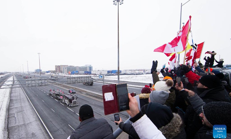 People gather on a bridge over Highway 400 in support of truckers, who are on their way to Ottawa for the freedom convoy protest, in Vaughan, Ontario, Canada, on Jan. 27, 2022. The freedom convoy was sparked by outrage over a vaccine mandate recently imposed on Canadian-U.S. cross-border truckers.(Photo: Xinhua)