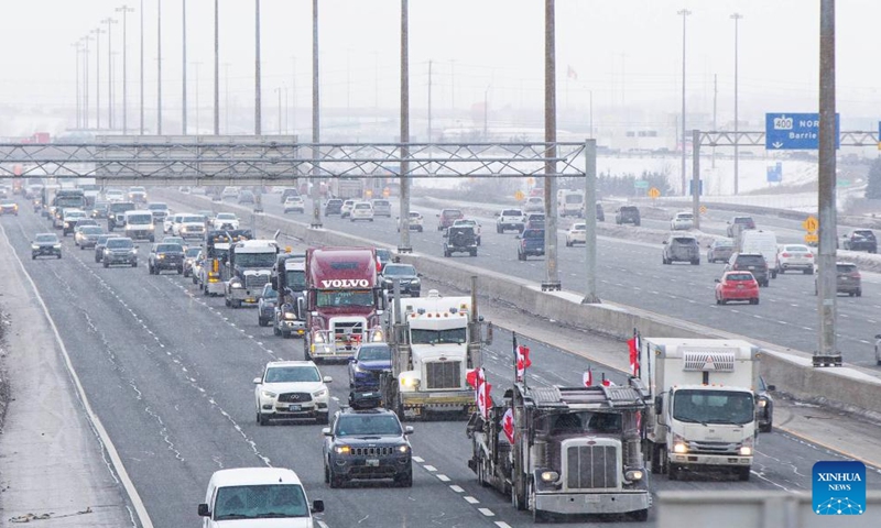 A line of trucks are seen on Highway 400 as truckers make their way to Ottawa during the freedom convoy protest in Vaughan, Ontario, Canada, on Jan. 27, 2022. The freedom convoy was sparked by outrage over a vaccine mandate recently imposed on Canadian-U.S. cross-border truckers.(Photo: Xinhua)