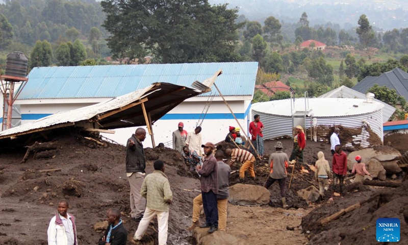 People gather at a floods affected area in Nyarusiza village, Kisoro District, Uganda, on Jan. 26, 2022. Torrential rains, floods and a mudslide have affected 800 people in three sub-counties in the western Ugandan district of Kisoro, a relief agency said on Thursday.(Photo: Xinhua)