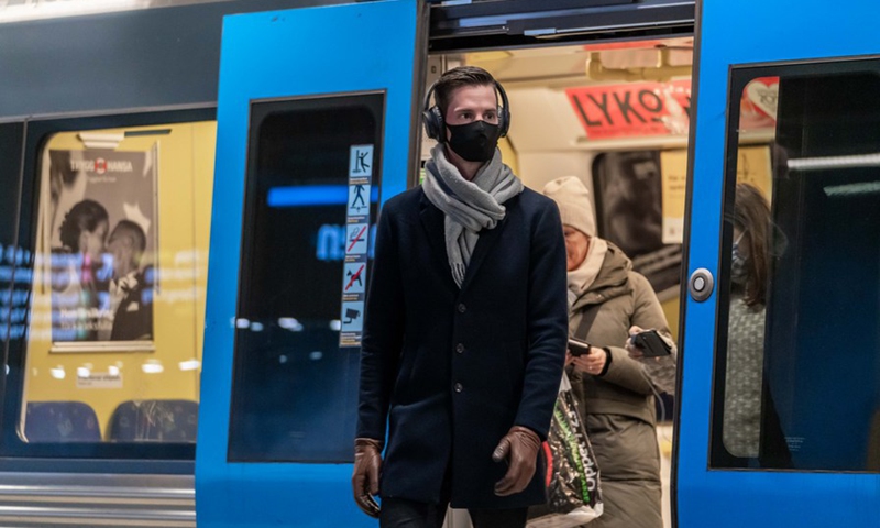 A passenger wearing a face mask gets off a subway train in Stockholm, Sweden, on Feb. 10, 2021.(Photo: Xinhua)