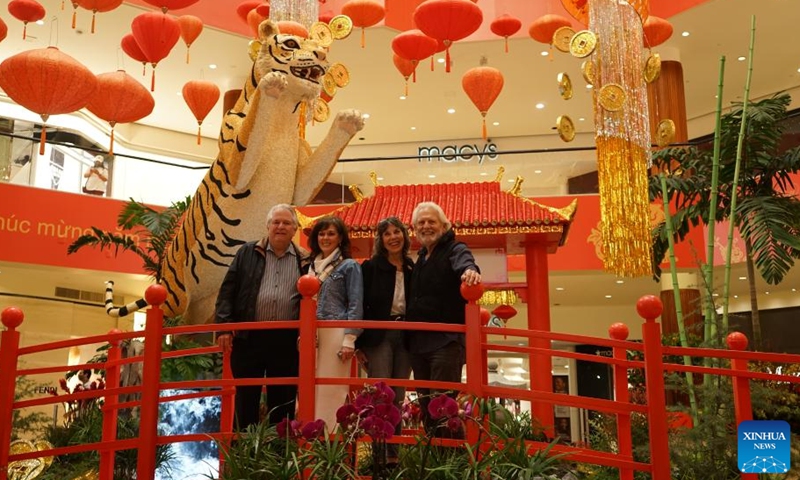 People pose for photos in front of tiger-themed decorations in South Coast Plaza, Orange County of California, the United States, on Jan. 27, 2022.Photo:Xinhua