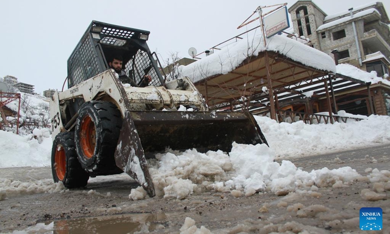 A bulldozer clears a road after snowstorms in the Bcharre district, northern Lebanon, on Jan. 28, 2022. (Photo: Xinhua)