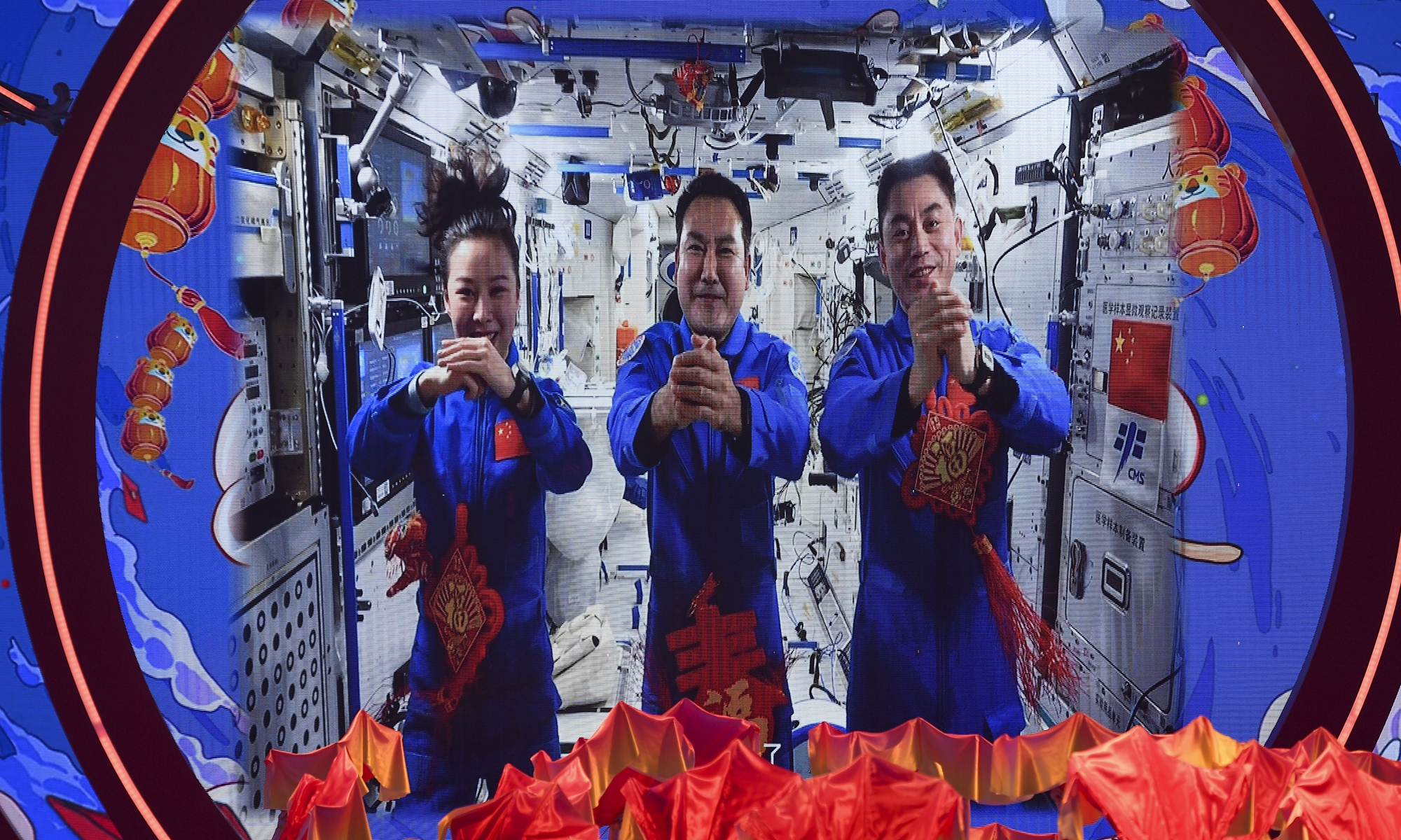 Shenzhou-13 taikonauts Zhai Zhigang, Wang Yaping and Ye Guangfu - who are living and working in the country's Tianhe space station core module - send blessings via video to all Chinese people around the world at a Chinese Lunar New Year gala held on January 22, 2022. Photo: cnsphoto

