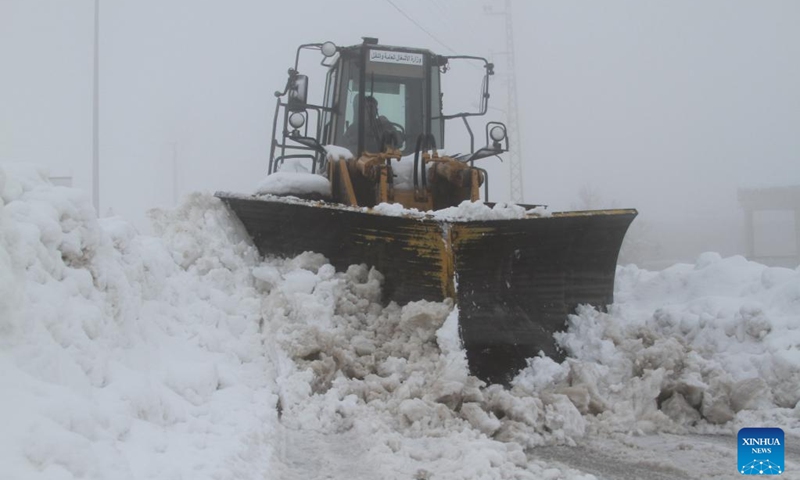 A bulldozer clears a snow-covered road after snowstorms in the Bcharre district, northern Lebanon, on Jan. 28, 2022.(Photo: Xinhua)
