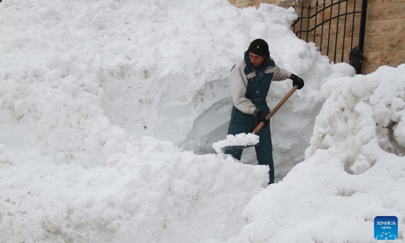 A man clears the way covered with snow after snowstorms in the Bcharre district, northern Lebanon, on Jan. 28, 2022.(Photo: Xinhua)