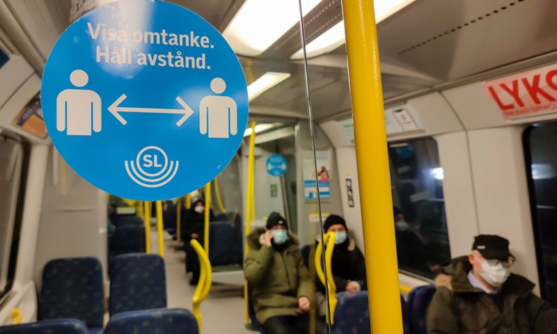 A blue sign reminding people to keep a distance is seen in a subway train in Stockholm, Sweden, on Feb. 10, 2021.(Photo: Xinhua)