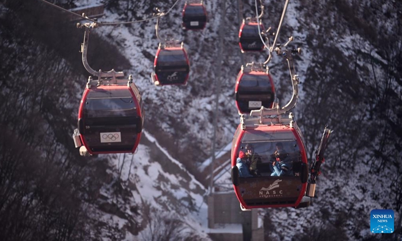 Staff members go to working area by cable cars at the National Alpine Skiing Center in Yanqing District, Beijing, capital of China, Jan. 28, 2022.Photo:Xinhua