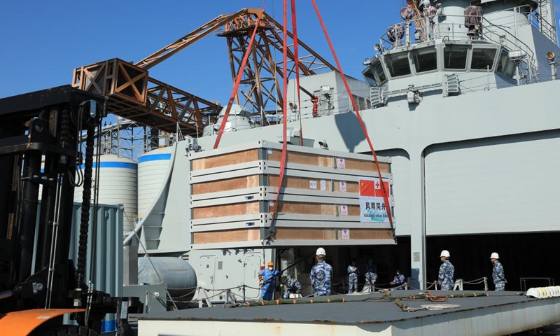 Relief supplies are transferred onto a ship waiting to depart for Tonga, in Guangzhou, south China's Guangdong Province, Jan. 30, 2022. (Photo by Xue Chengqing/Xinhua)