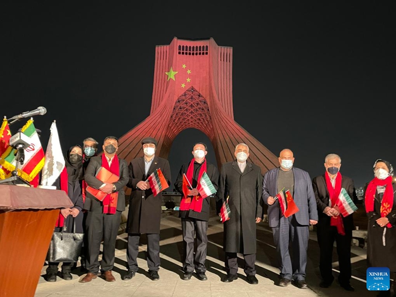 Chinese Ambassador to Iran Chang Hua (5th R) and Iranian representatives pose for a photo in front of the Azadi Tower during a light show to mark the Chinese Lunar New Year in Tehran, Iran, on Jan. 31, 2022. (Chinese Embassy in Iran/Handout via Xinhua)
