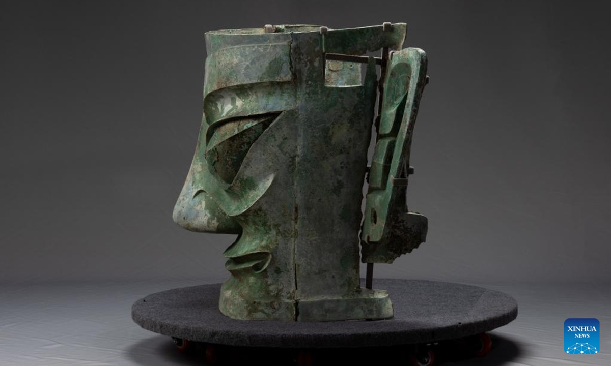 File photo shows staff members repairing the bronze mask discoverd at the Sanxingdui Ruins site in southwest China's Sichuan Province. The largest bronze mask unearthed from the legendary Sanxingdui Ruins site in Sichuan met the public at Monday's Spring Festival TV Gala. (National Cultural Heritage Administration/Handout via Xinhua)