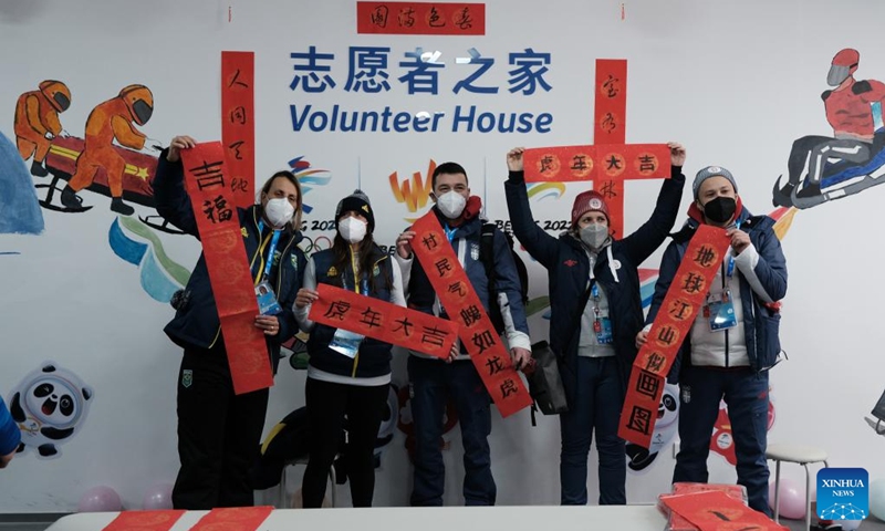Delegation members show Spring Festival couplets at the Olympic Village for the Beijing 2022 Winter Olympics in Yanqing District of Beijing, capital of China, Jan. 31, 2022. Delegation members and volunteers celebrated the Chinese Lunar New Year, or the Year of Tiger at the Olympic Village on Monday. (Photo by Zheng Weibo/Xinhua)