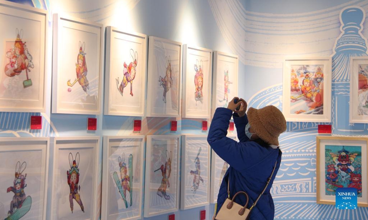 People visit an exhibition of New Year pictures in Xicheng District of Beijing, capital of China, Feb. 1, 2022. The exhibition kicked off here on Jan. 25, featuring more than 270 New Year pictures created to commemorate the arrival of the lunar new year in the Chinese tradition. (Xinhua/Tang Rufeng)
