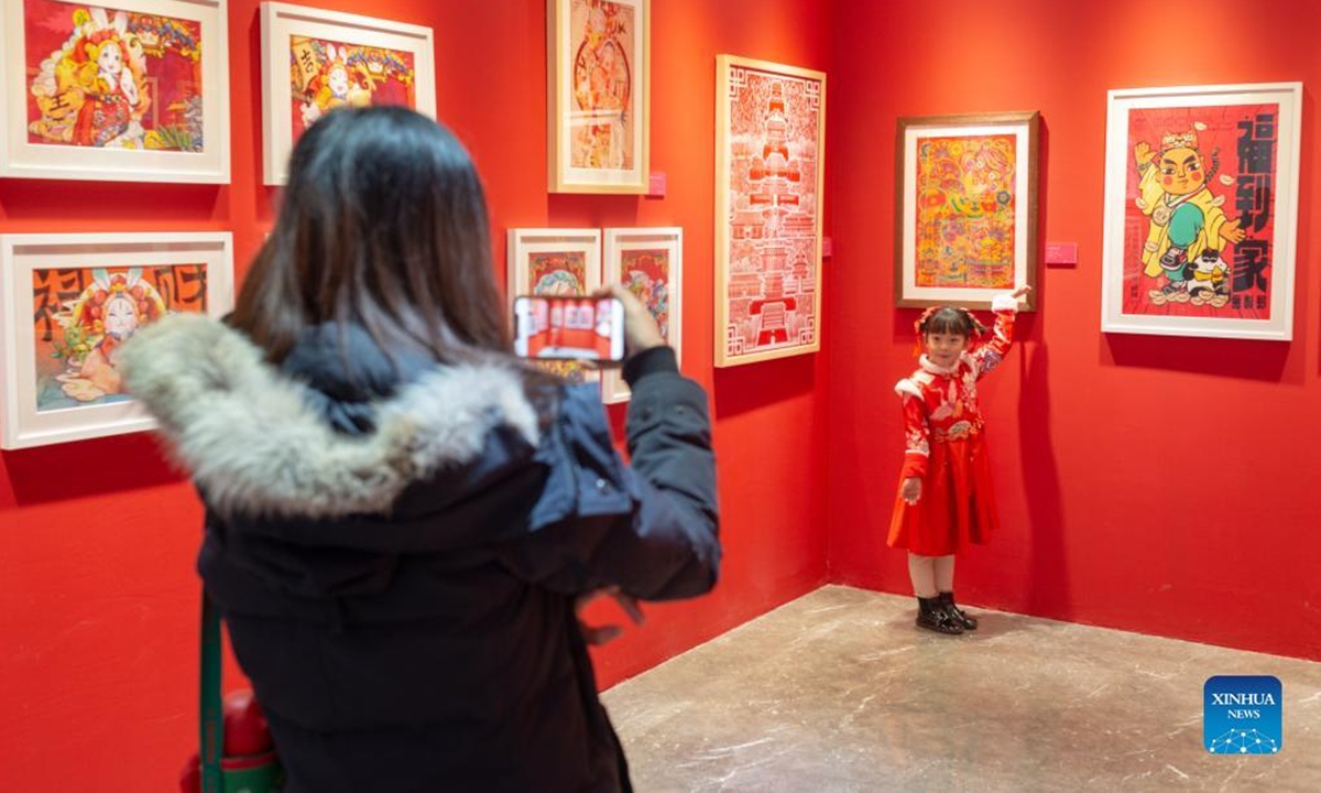 People visit an exhibition of New Year pictures in Xicheng District of Beijing, capital of China, Feb. 1, 2022. The exhibition kicked off here on Jan. 25, featuring more than 270 New Year pictures created to commemorate the arrival of the lunar new year in the Chinese tradition. (Xinhua/Tang Rufeng)
