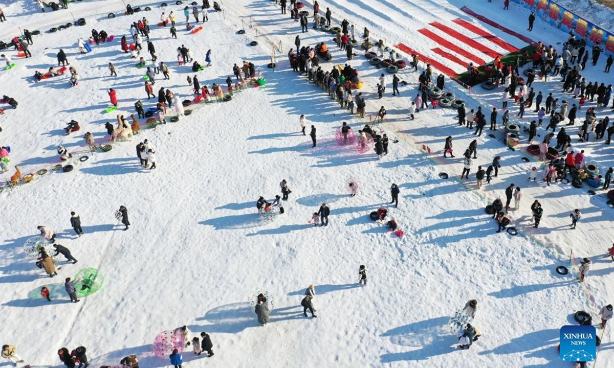 Tourists play at a snow park in Zaozhuang, east China's Shandong Province on Feb. 1, 2022. Various activities are held during the Spring Festival holidays. (Photo by Li Zongxian/Xinhua)