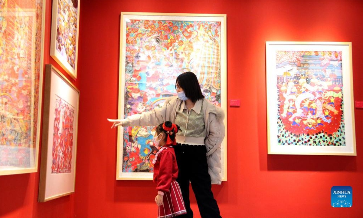 People visit an exhibition of New Year pictures in Xicheng District of Beijing, capital of China, Feb. 1, 2022. The exhibition kicked off here on Jan. 25, featuring more than 270 New Year pictures created to commemorate the arrival of the lunar new year in the Chinese tradition. (Xinhua/Tang Rufeng)
