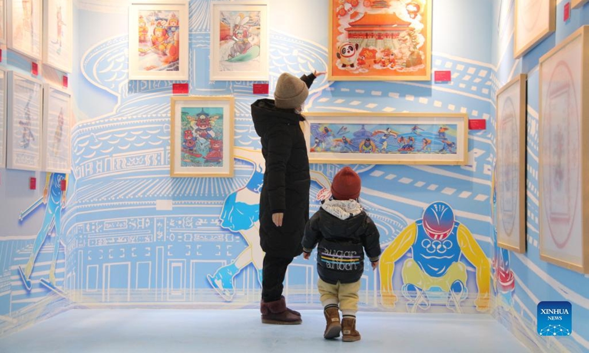 People visit an exhibition of New Year pictures in Xicheng District of Beijing, capital of China, Feb. 1, 2022. The exhibition kicked off here on Jan. 25, featuring more than 270 New Year pictures created to commemorate the arrival of the lunar new year in the Chinese tradition. (Xinhua/Tang Rufeng)
