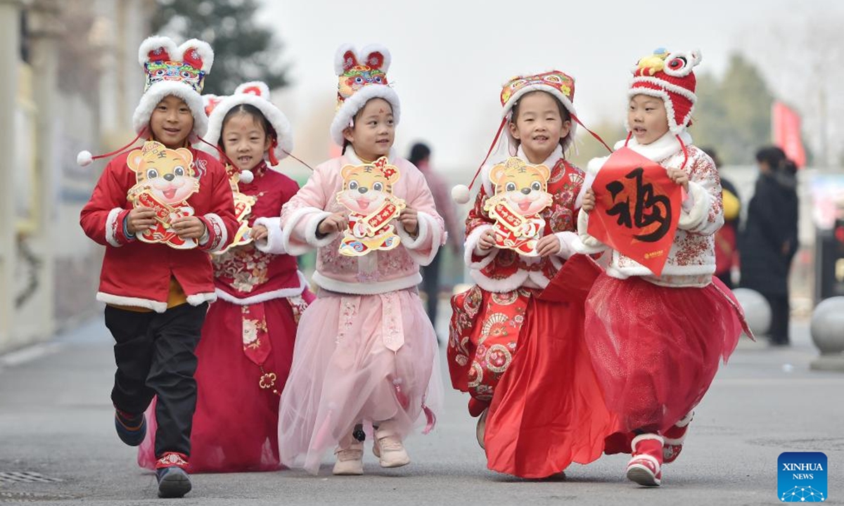 Children wearing tiger-themed hats are seen with decorations on their hands in Hefei, east China's Anhui Province, Jan. 18, 2022. With the arrival of Chinese New Year on Tuesday, the country enters the Year of the Tiger.


