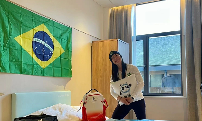 Nicole Silveira holds Winter Olympic mascot Bing Dwen Dwen pillow in her room at the Olympic Village. Photo: Courtesy of Silveira