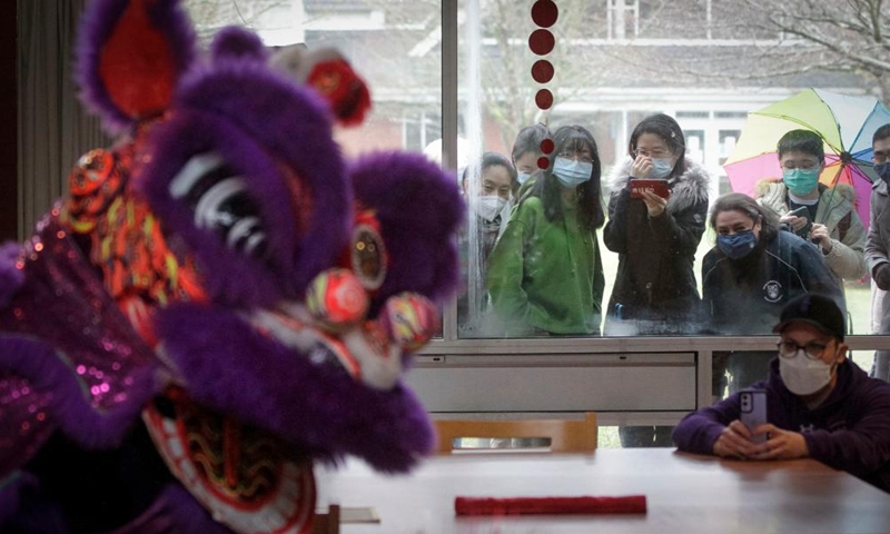 A man films a lion dance at St. John's College, the University of British Columbia, in Vancouver, British Columbia, Canada, on Feb. 3, 2022.Photo:Xinhua