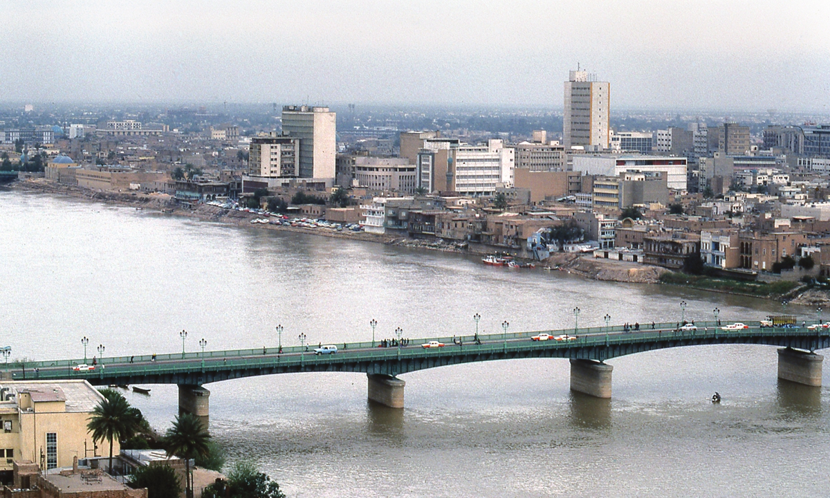 Cars and pedestrians cross a bridge spanning the Tigris river in the Iraqi capital city of Baghdad. Photo: VCG