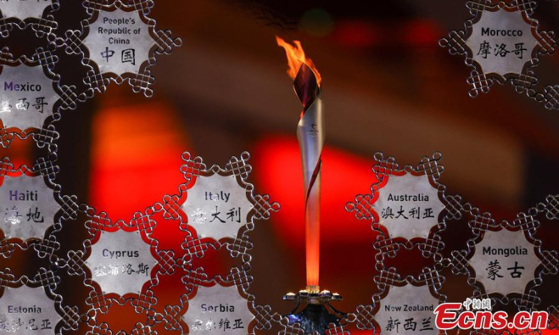 The Olympic flame burns inside the snowflake-shaped torch stand outside the National Stadium in Beijing, or the “Bird's Nest”, Feb. 6, 2022. (Photo/VCG)