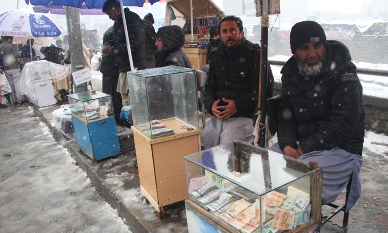 Currency exchange dealers wait for customers in Kabul, Afghanistan, Feb. 6, 2022.Photo:Xinhua