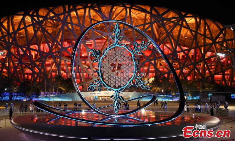 The Olympic flame burns inside the snowflake-shaped torch stand outside the National Stadium in Beijing, or the “Bird's Nest”, Feb. 6, 2022. (Photo/VCG)