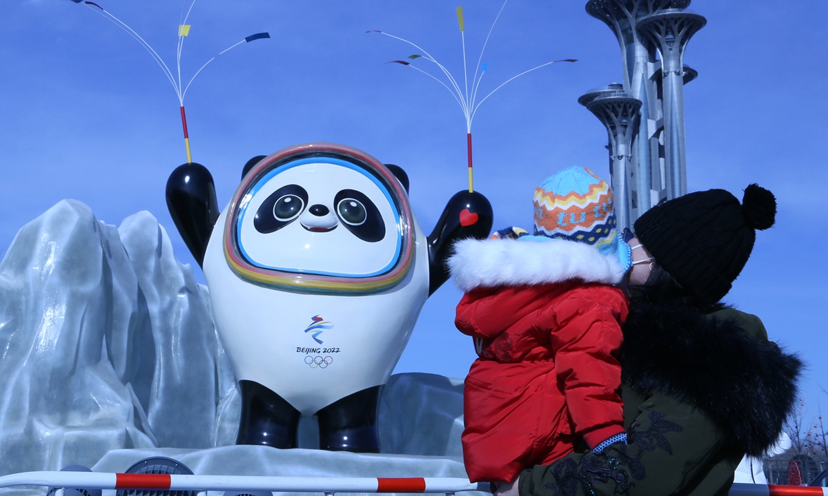 Residents in Beijing take pictures with Bing Dwen Dwen, the mascot for the Beijing 2022 Winter Olympic Games, on February 6, 2022. The cuddly mascot is currently in short supply in China and stores have restricted purchases by customers. Photo: VCG
