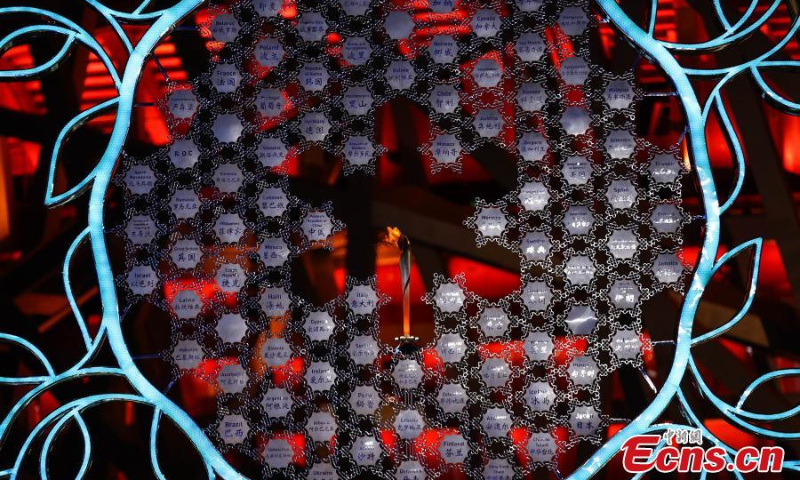 The Olympic flame burns inside the snowflake-shaped torch stand outside the National Stadium in Beijing, or the “Bird's Nest”, Feb. 6, 2022. (Photo/VCG)