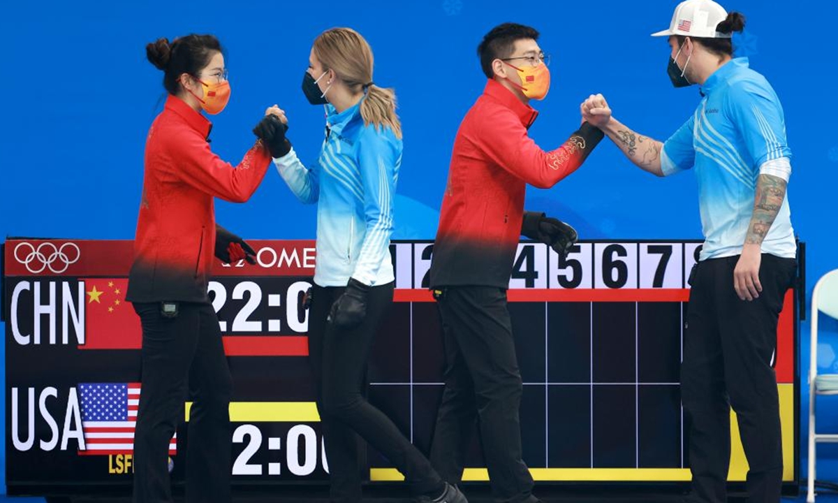 China's atheletes Fan Suyuan (1st left) and Ling Zhi (2nd rifht) greet their opponents Vicky Persinger (2nd left) and Christopher Plys of US during the curling mixed doubles round robin event of the Beijing 2022 Winter Olympics between China and the US at National Aquatics Centre in Beijing, capital of China, Feb. 5, 2022. Photo: Xinhua