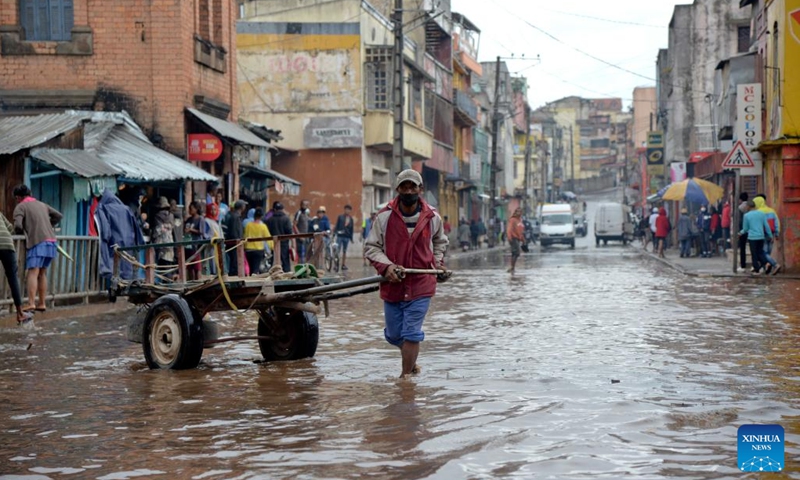 A man pulling a cart wades through a flooded road in Antananarivo, Madagascar, on Feb. 6, 2022. A total of 20 deaths were recorded Monday in Madagascar by the Office of Risk and Disaster Management, following the passage of intense tropical cyclone Batsirai Saturday and Sunday.(Photo: Xinhua)