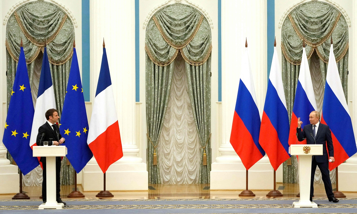 Russian President Vladimir Putin (right) gestures during a joint press conference with visiting French President Emmanuel Macron in Moscow, on February 7, 2022, after bilateral negotiations to defuse the tension over Ukraine. Russia and France have common security concerns in Europe, Putin told Macron during their meeting. Putin said the negotiation was 