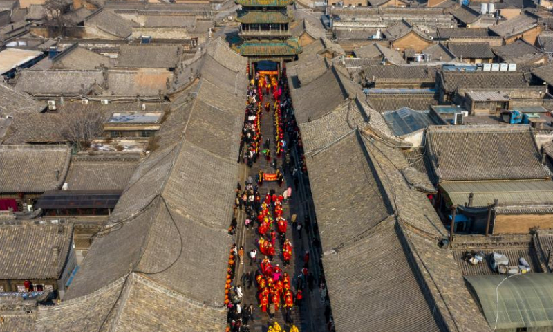 Aerial photo shows a view of the Pingyao Ancient Town during the Spring Festival in Jinzhong City, north China's Shanxi Province, Feb. 8, 2022. With a history of over 2,800 years, Pingyao was named a world heritage site by UNESCO in 1997. It is best known for its almost intact Ming Dynasty (1368-1644) city walls and well-preserved architectures, and is a popular destination for both Chinese and overseas tourists.  (Xinhua)