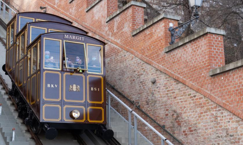 The 152-year-old Buda Castle Hill Funicular is seen as it restarts after a renovation in Budapest, Hungary on Feb. 8, 2022. The Buda Castle Hill Funicular, starting on March 2, 1870, is a tourist attraction of Budapest. After a big renovation, it reopened on Feb. 8. (Photo by Attila Volgyi/Xinhua)
