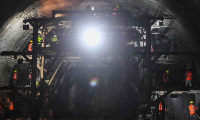Staff members work in a tunnel of the Yukun high-speed railway in southwest China's Chongqing Municipality, Feb. 9, 2022. The construction of the Yukun high-speed railway linking Chongqing and Kunming, capital of southwest China's Yunnan Province, is in acceleration after the Spring Festival holidays. The railway is expected to slash the travel time between the two cities from five hours to two hours. (Xinhua)