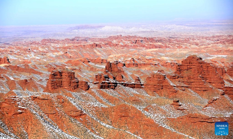 Photo taken on Feb. 8, 2022 shows the snow scenery of Danxia landform, characterized by reddish sandstone features, at Zhangye Danxia National Geological Park in Zhangye, northwest China's Gansu Province.(Photo: Xinhua)